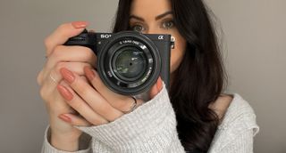 Sony A6700 being held by the reviewer