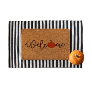 Halloween doormat that says welcome with a pumpkin