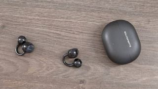The Soundpeats Pop Clip2 on a wooden table.