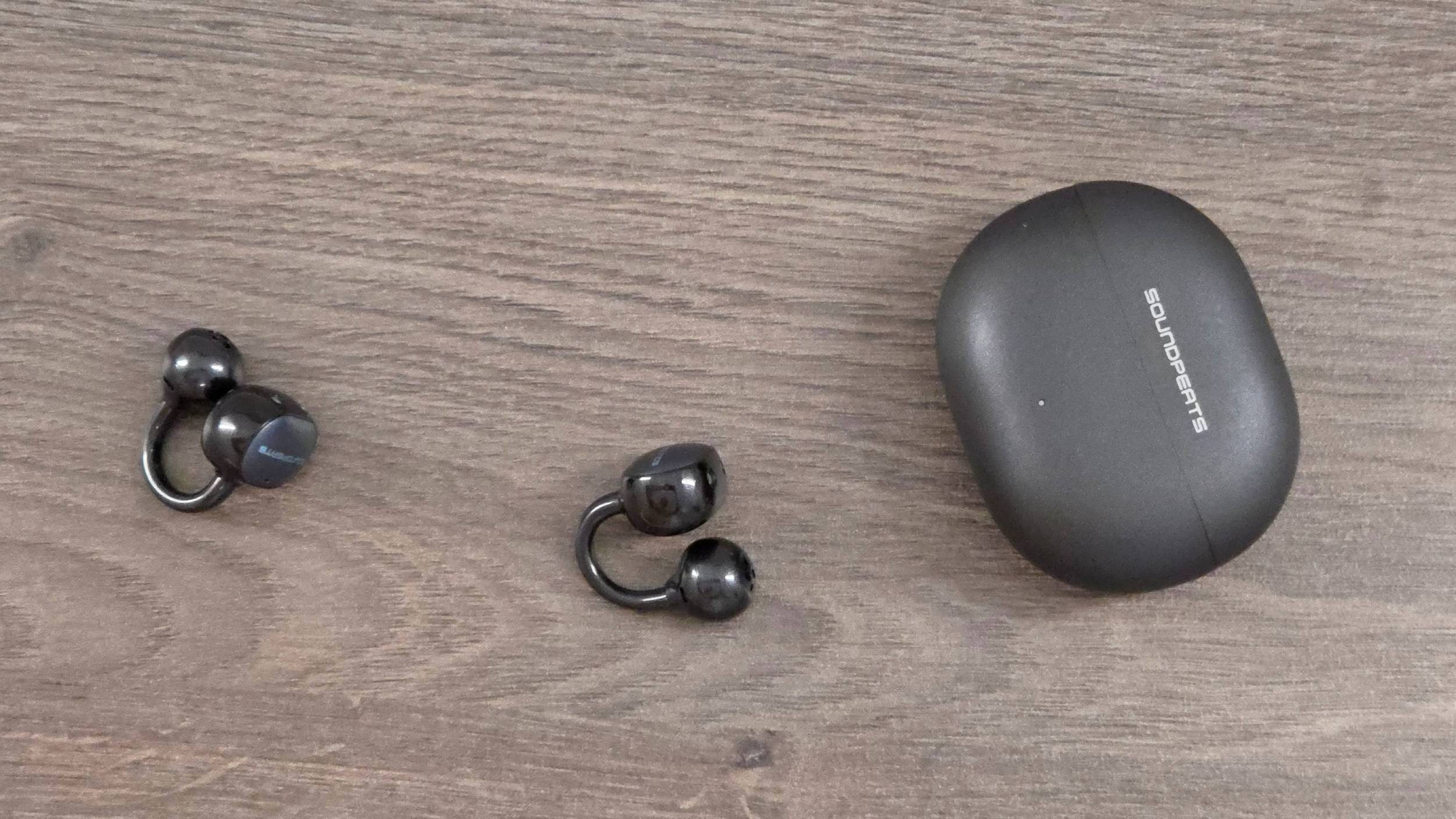 The Soundpeats Pop Clip2 on a wooden table.