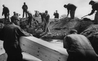 Prisoners bury Bowery men who were poisoned by drinking wood alcohol.