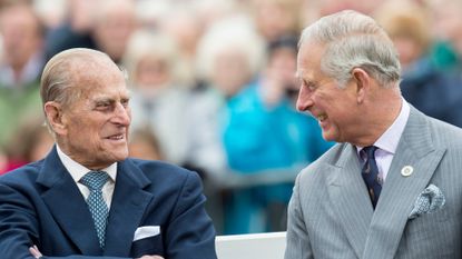 Prince Philip and Prince Charles share a joke 