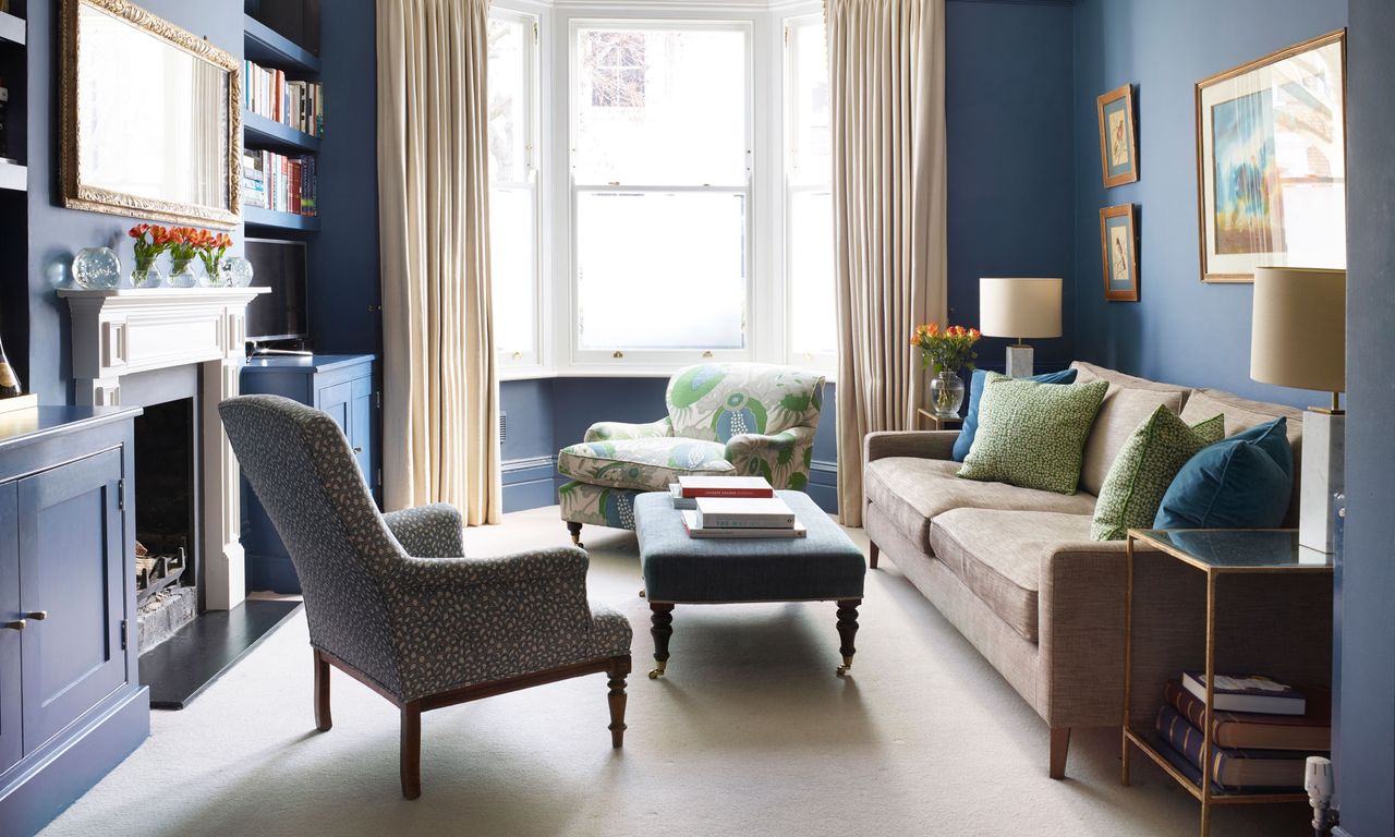 living room with dark blue walls and arm chairs