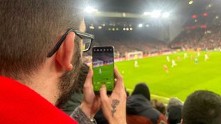 T3's Sam Cross testing the Oppo Find X8 Pro at Anfield, Liverpool, during the Champions League tie between Liverpool and Lille