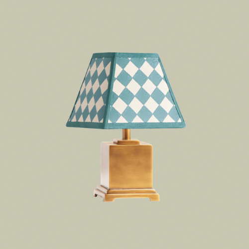 A lamp with a brass base and a blue and white checkered lampshade