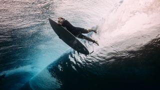 Image of a surfer from below the water