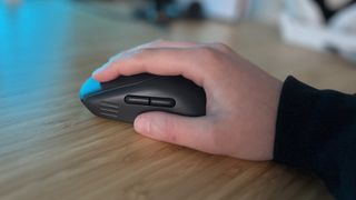 Hand placed in a palm grip using the Alienware Pro Wireless gaming mouse