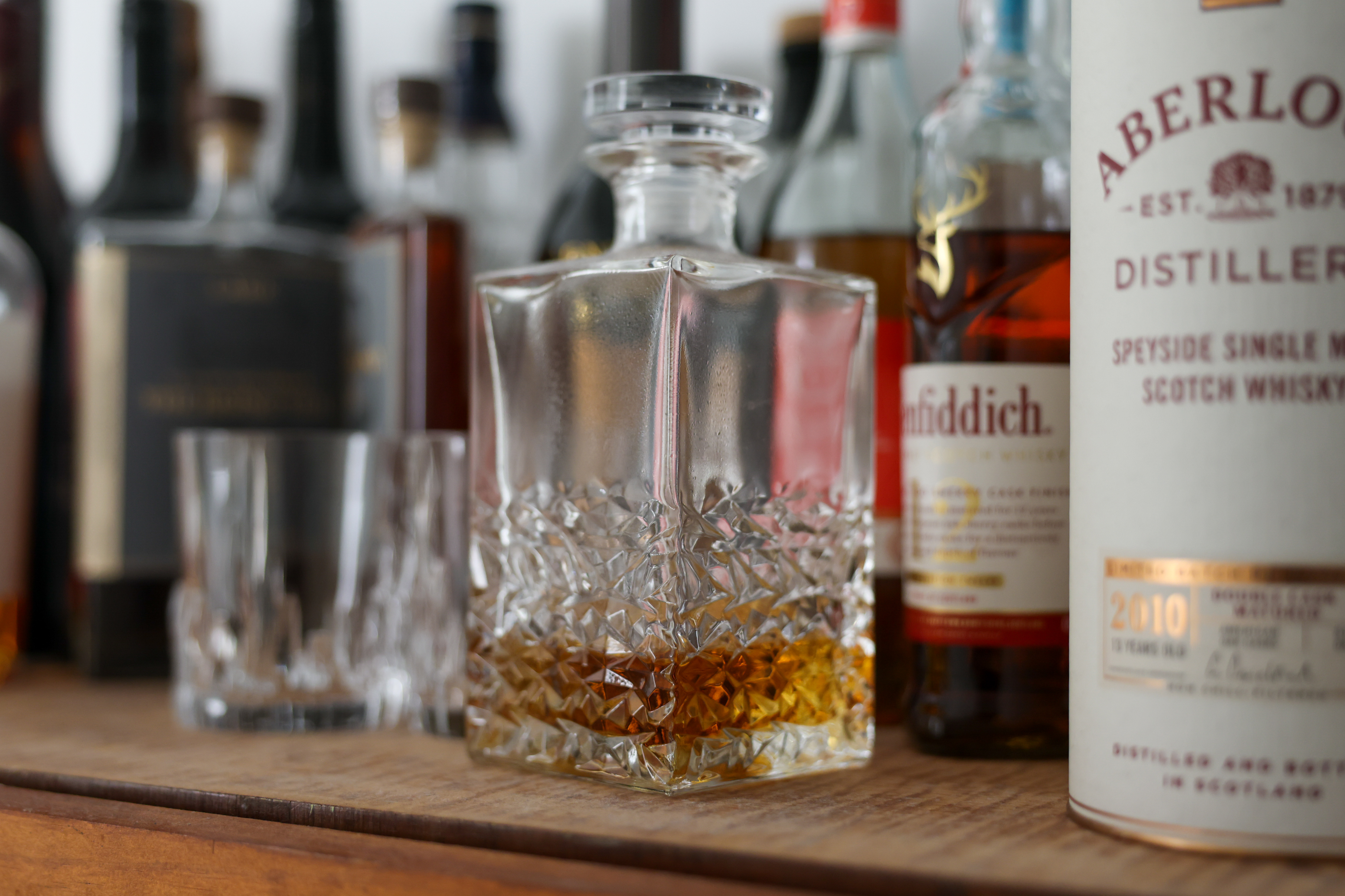 A whisky decanter on a bar top shot at ISO 1250