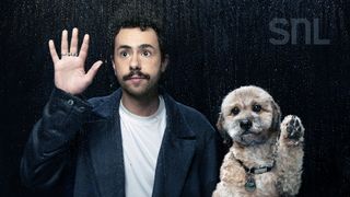 ramy yousseff lifts his hand up while his dog lifts up a paw in a portrait from when he hosted saturday night live