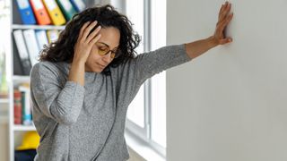 Woman suffering from dizziness with difficulty standing up.