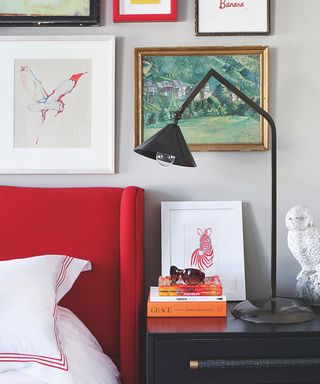 Industrial bedroom with red headboard and black lamp