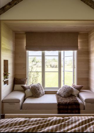 A sleeping nook built beneath windows