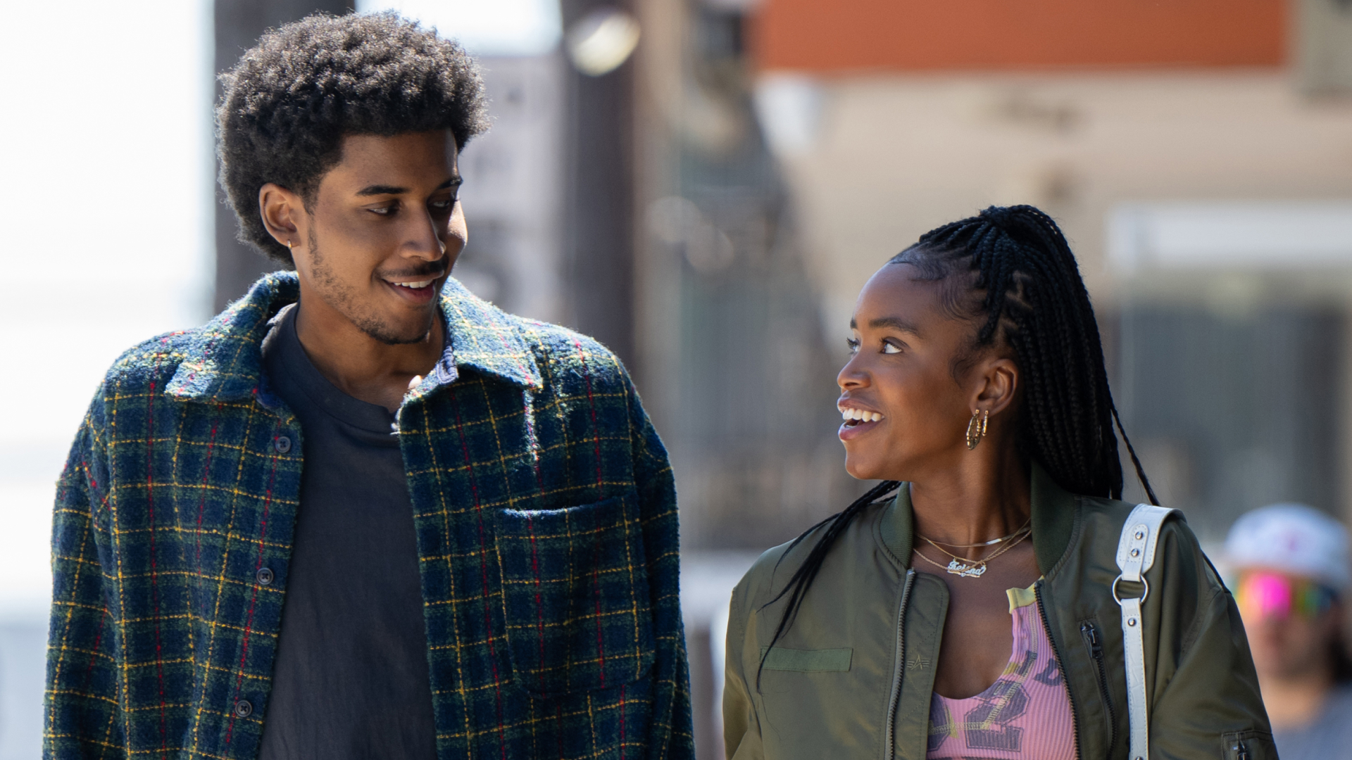 Michael Cooper Jr. as Justin Edwards and Lovie Simone as Keisha Clark walking through los angeles and smiling at each other in the tv show forever