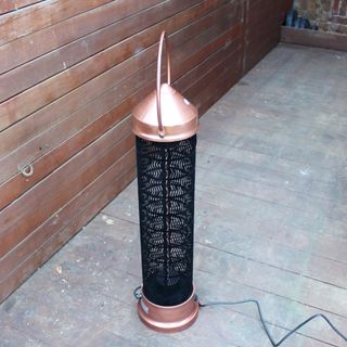 The Kettler Kalos copper lantern patio heater being tested on wooden decking