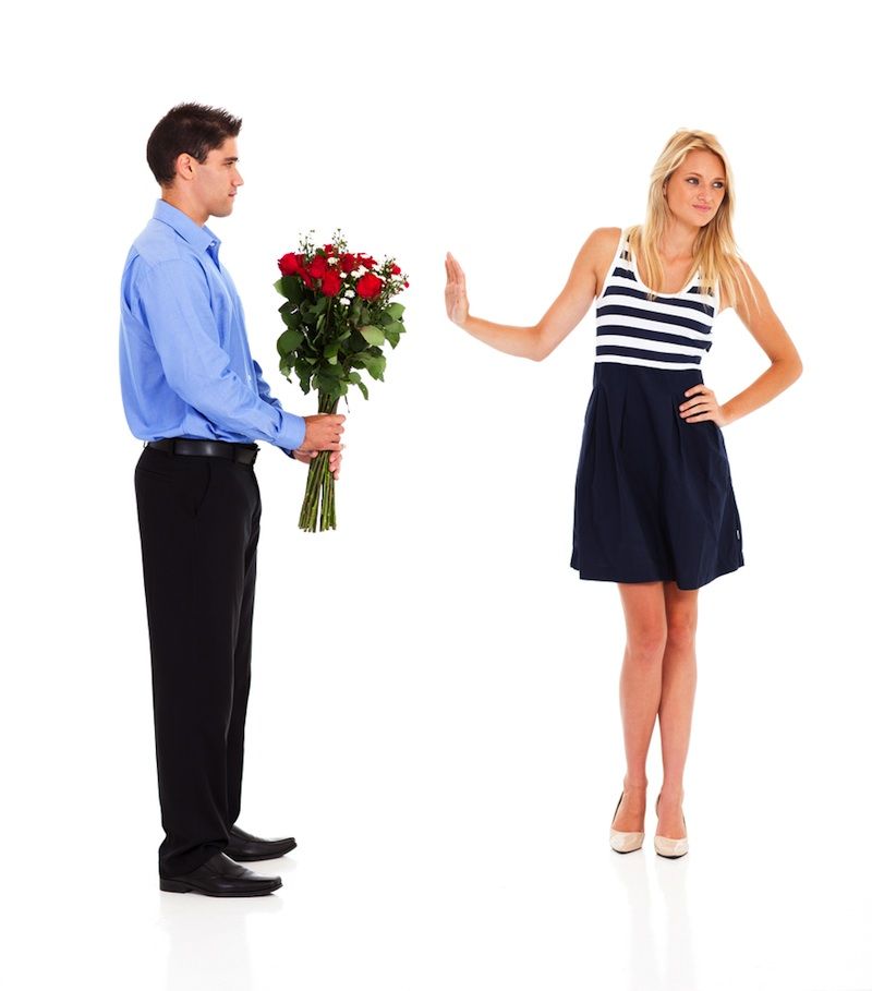 woman rejecting man&#039;s flowers