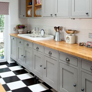 kitchen with black and white tiles wooden worktop