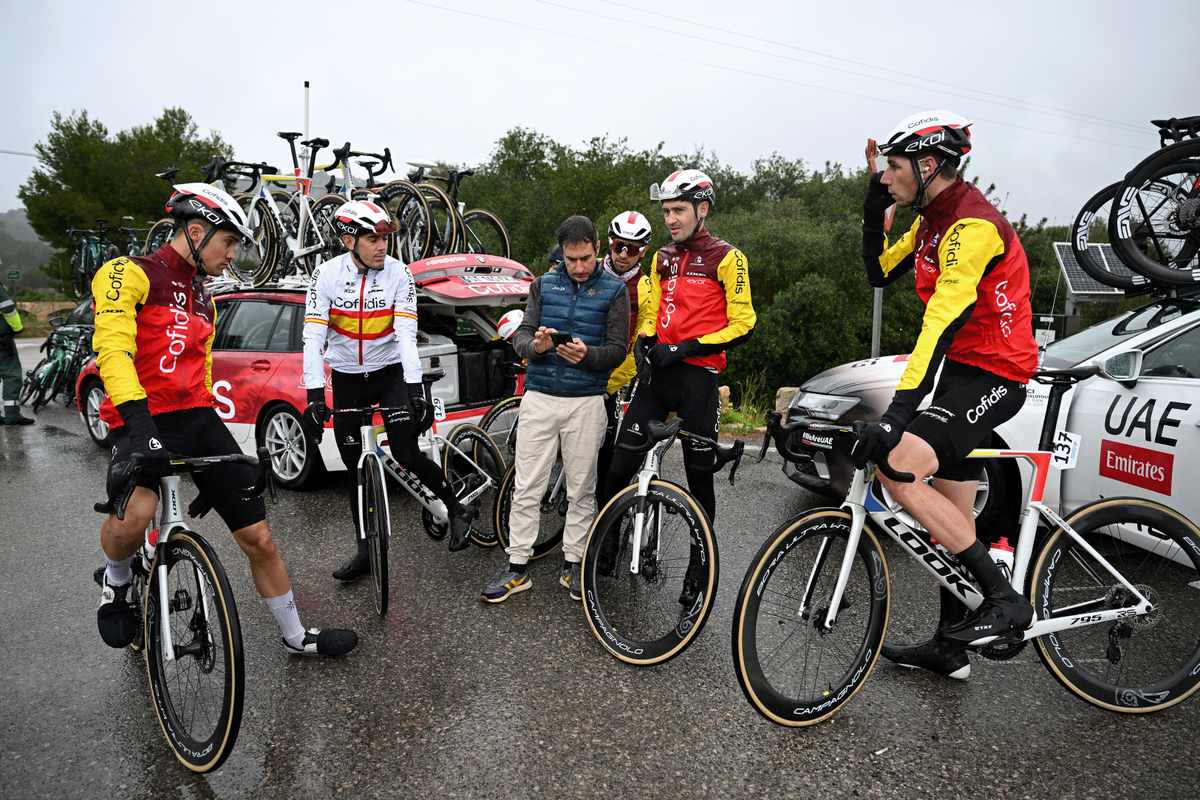 Team Cofidis wait by the team car after the Trofeo Andratx - Pollenca is cancelled