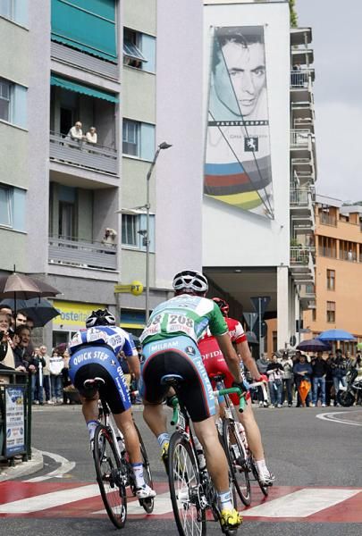 The winning break passes a larger than life Fausto Coppi banner.