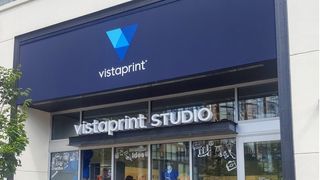 A Vistaprint Studio storefront with a tree outside