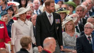 Britain's Prince Harry, Duke of Sussex (C) and Britain's Meghan, Duchess of Sussex (centre left) attend the National Service of Thanksgiving for The Queen's reign at Saint Paul's Cathedral in London on June 3, 2022 as part of Queen Elizabeth II's platinum jubilee celebrations (Photo by ARTHUR EDWARDS / POOL / AFP) (Photo by ARTHUR EDWARDS/POOL/AFP via Getty Images)