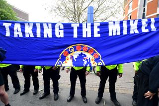 Chelsea fans refer to their former midfielder John Obi Mikel during their protest