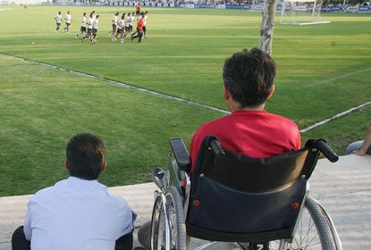 Disabled fan watching a football game