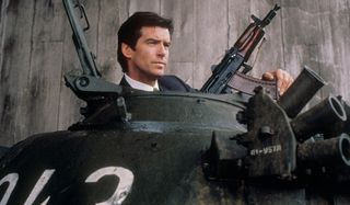 Goldeneye Pierce Brosnan holds a machine gun while riding a tank