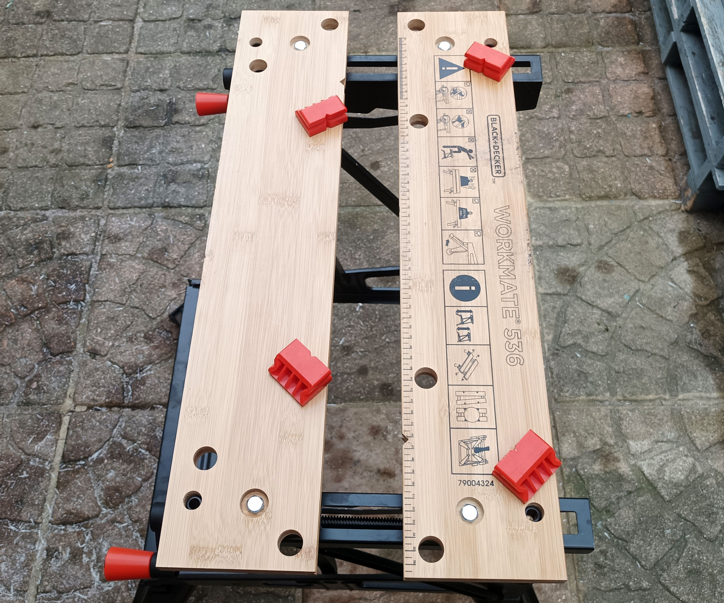 Black &amp;amp; Decker Workmate WM536 with orange grips in different positions on patio