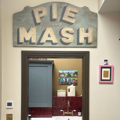 vintage pie and mash sign above a green doorframe