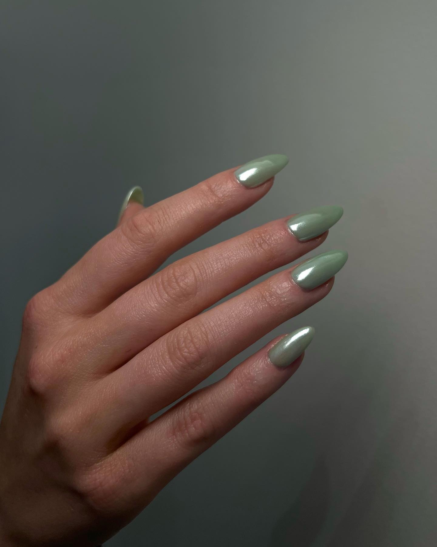 Long almond sage green glazed chrome nails