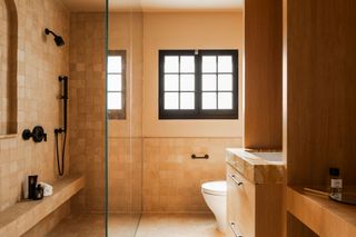 a honey-toned bathroom with zellige tiles