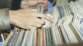 Hands crate digging in a record store