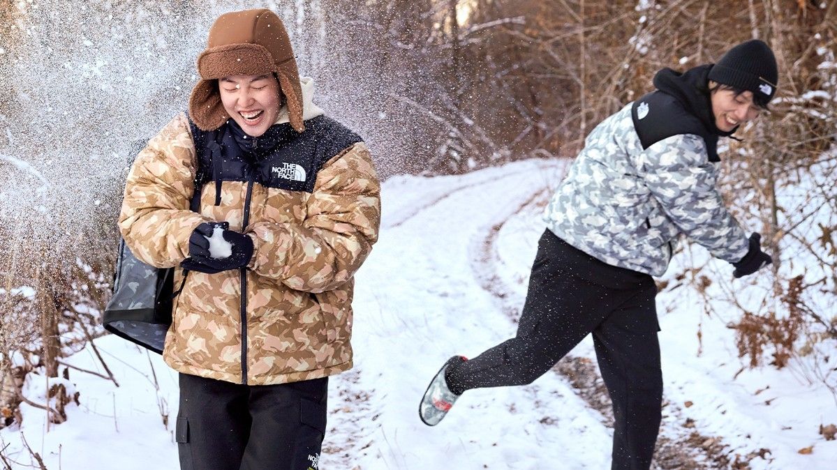 People wearing North Face Lunar New Year jackets having snowball fight