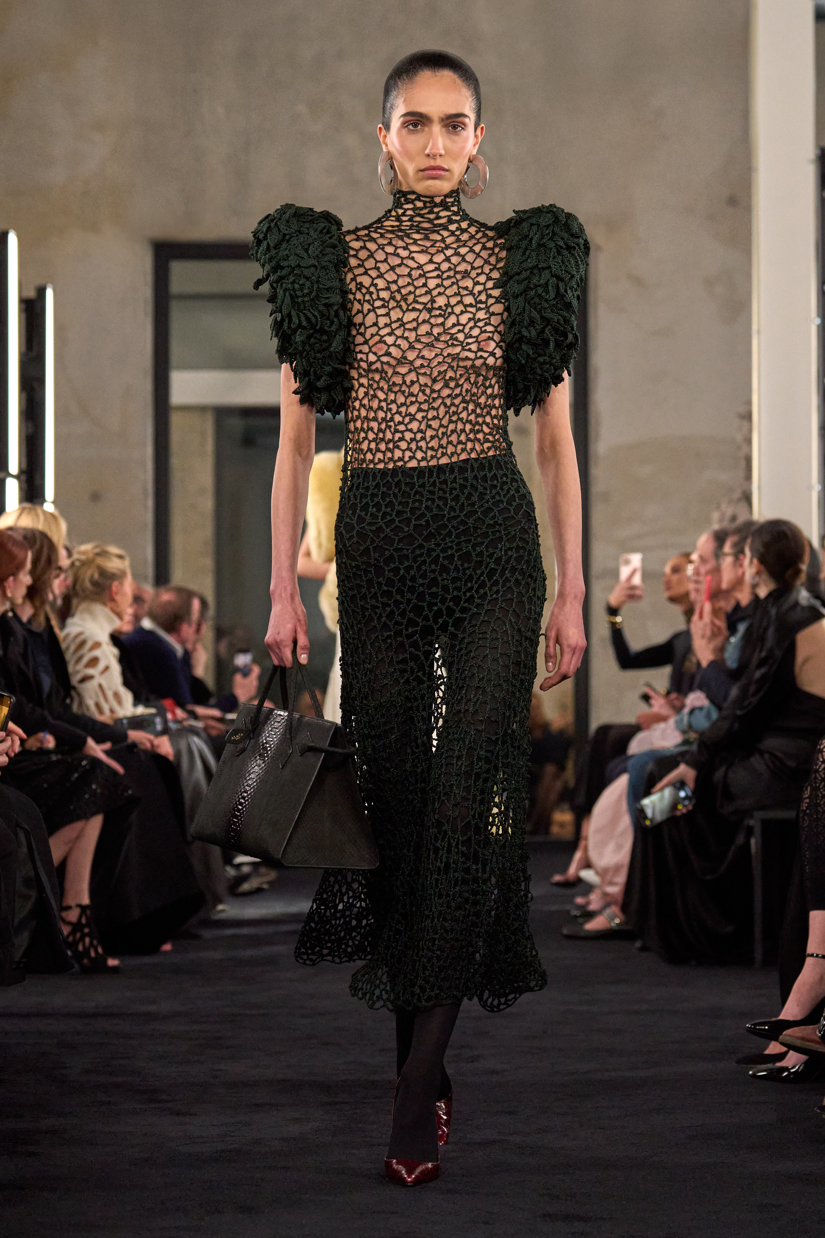 a model wears a net dress in Alaïa fall 2025 runway show