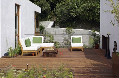 A deck with upholstered outdoor furniture