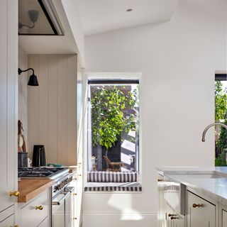 window seat in a pale, neutral kitchen