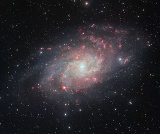 M33, the Triangulum Galaxy, taken by the VLT Survey Telescope at the European Southern Observatory's Paranal Observatory in Chile. The picture reveals gassy regions, shown in red.