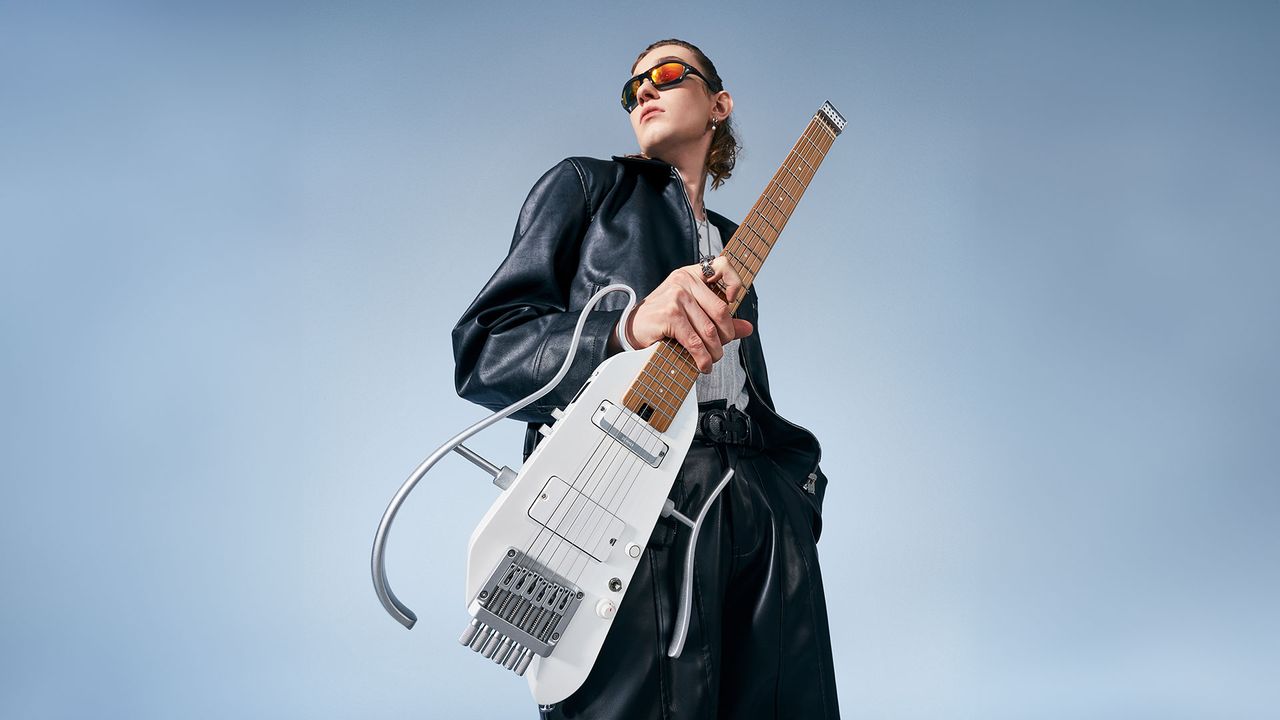 A guitarist holds the Donner Hush-X Pro