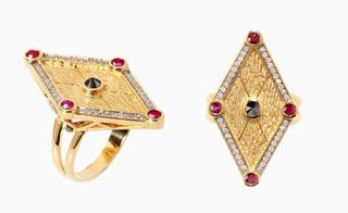 Amulet-like graphic lines of this ring set with rubies and black diamonds 