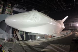 a space shuttle orbiter is wrapped in white plastic