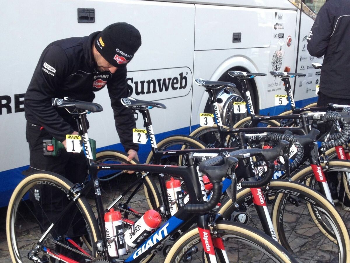 A mechanic checks the pressure of the tyres