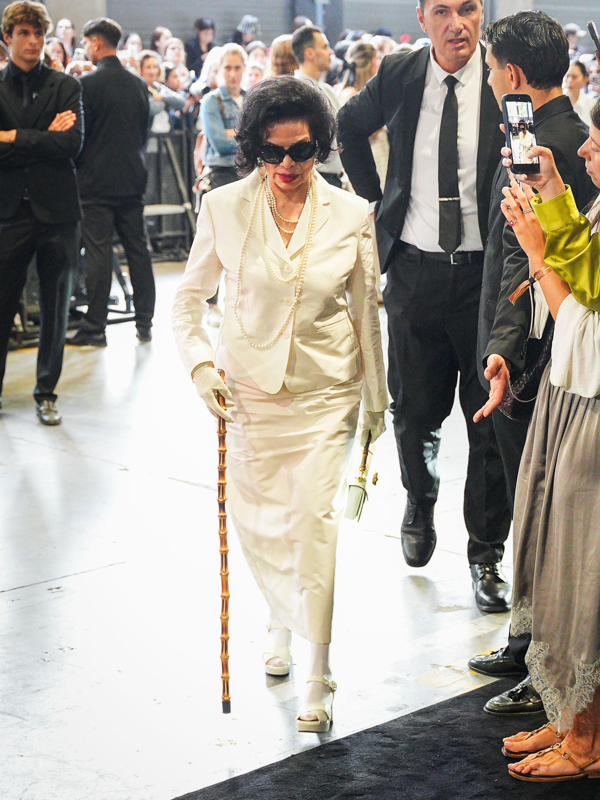 Bianca Jagger styled a bridal-white blazer and a matching pencil skirt at the Gucci Spring/Summer 2027 show at Milan Fashion Week