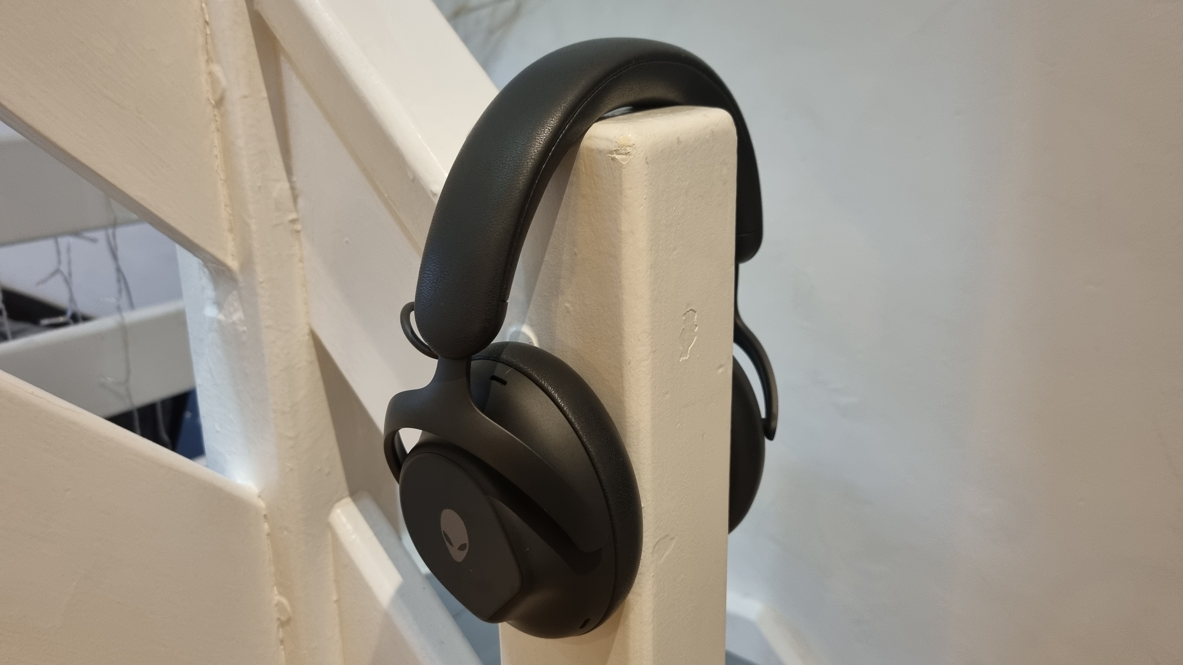 The Alienware Pro Wireless Gaming Headset on a stair banister, showing how it might look when worn.