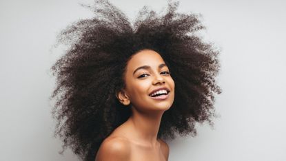 Woman with textured hair smiling