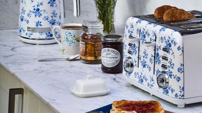 The VQ &amp; Laura Ashley China Rose toaster and kettle on a marble countertop with toast and condiments around it