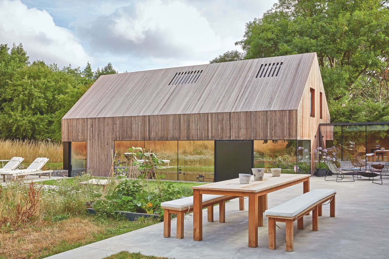 timber clad extension with lots of glass and garden