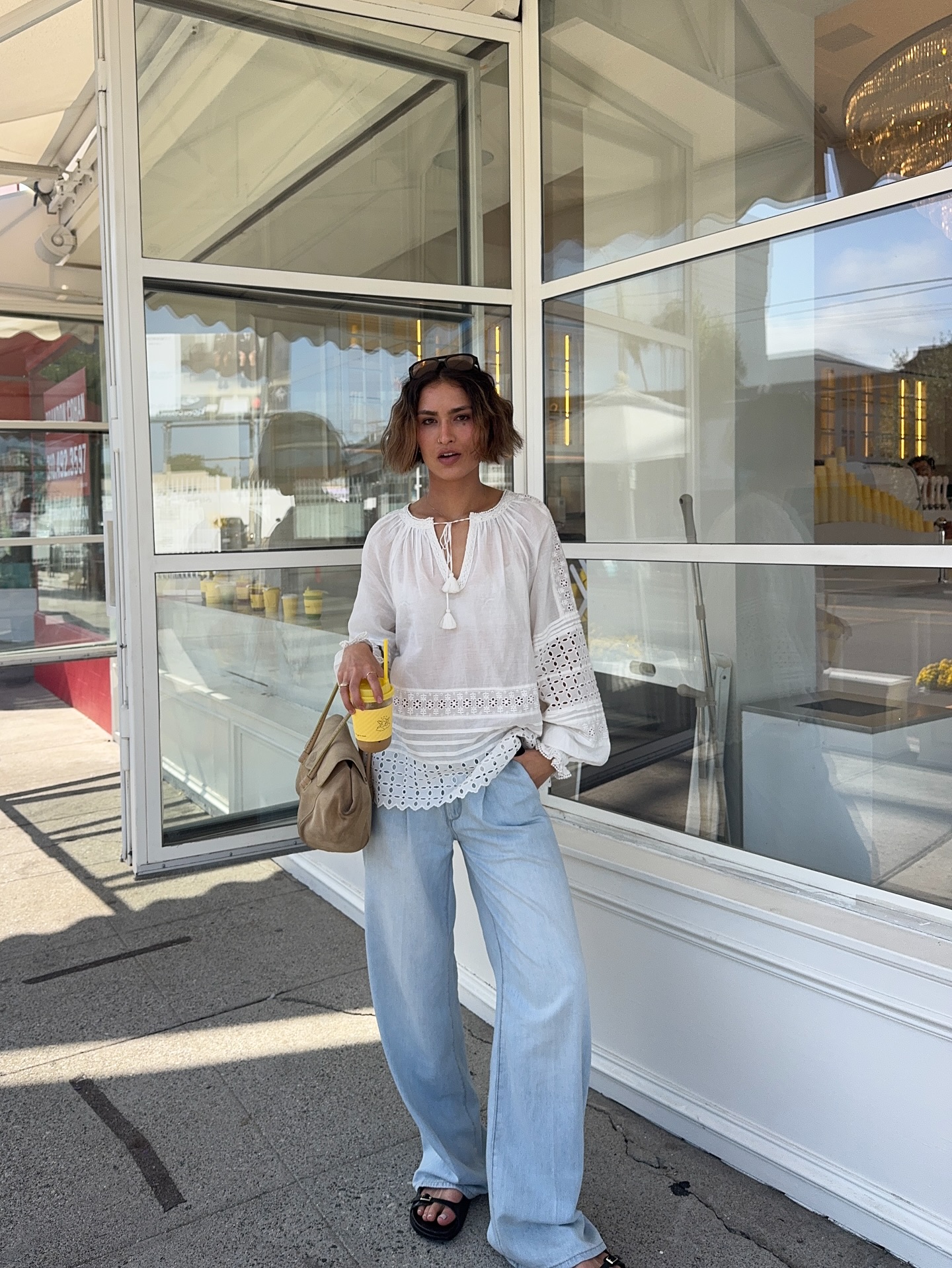 caitlin miyako wears a tie front blouse, jeans and chunky black sandals