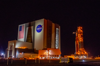 NASA's Artemis 1 moon mission stack rolls toward the Vehicle Assembly Building at Kennedy Space Center in Florida in the early morning hours of April 26, 2022.