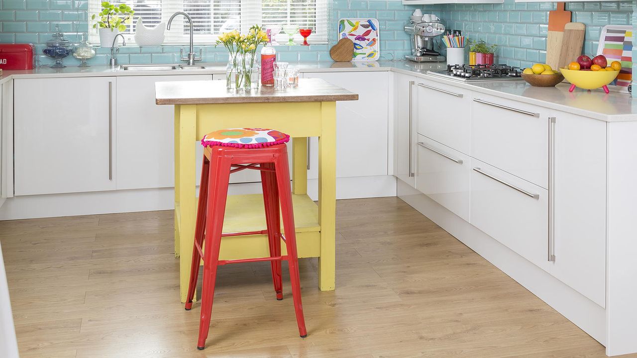 yellow kitchen island with red bar stool