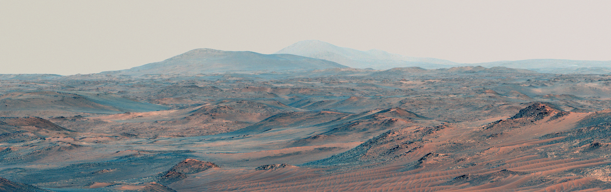A panorama view of the reddish blueish dunes of Mars